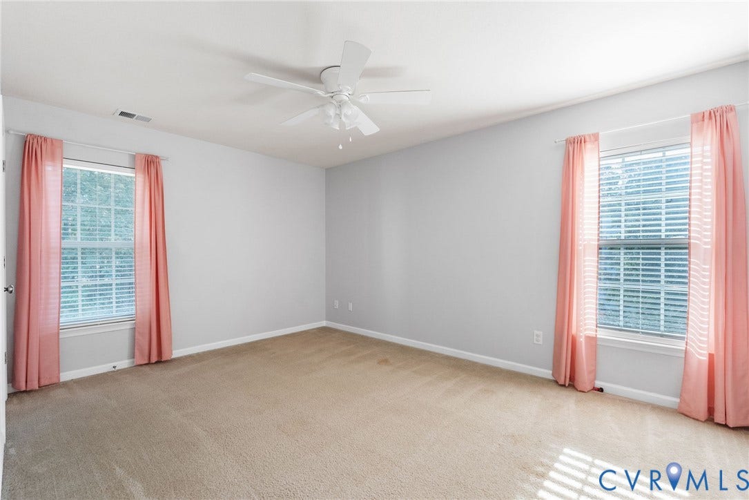 6852 Watch Harbour Circle, Hayes, VA 23072 Carpeted flooring with light gray walls, two windows with blinds, and a ceiling fan with integrated lighting