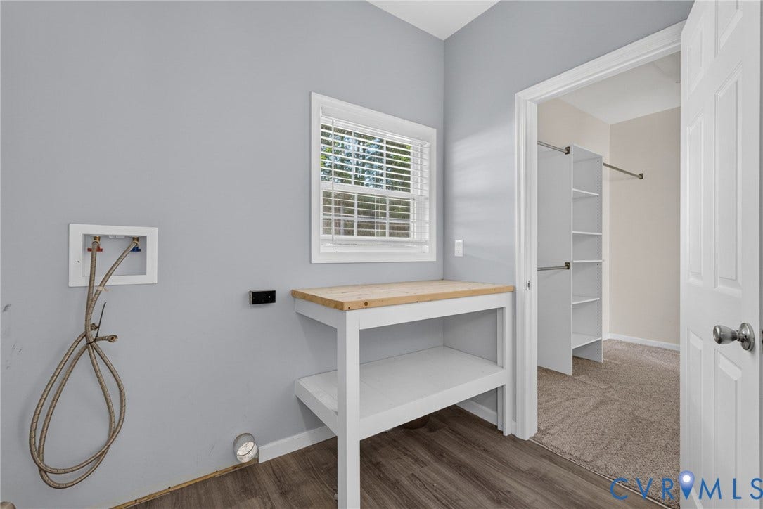 6852 Watch Harbour Circle, Hayes, VA 23072 Wood-finish flooring, built-in workbench, window with blinds, and laundry hookups