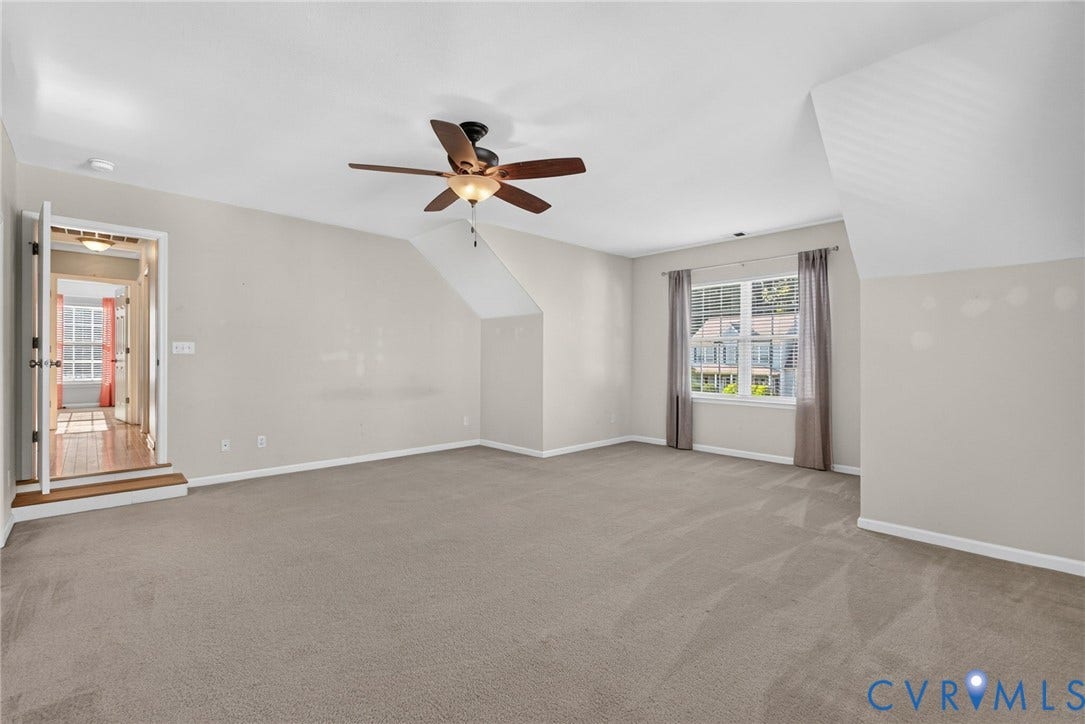 6852 Watch Harbour Circle, Hayes, VA 23072 Carpeted room featuring a ceiling fan, sloped ceiling, and multiple windows