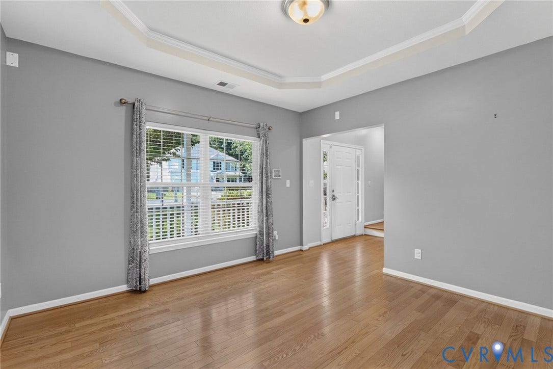 6852 Watch Harbour Circle, Hayes, VA 23072 Recessed tray ceiling, wood-finish flooring, white trim, and a window with blinds