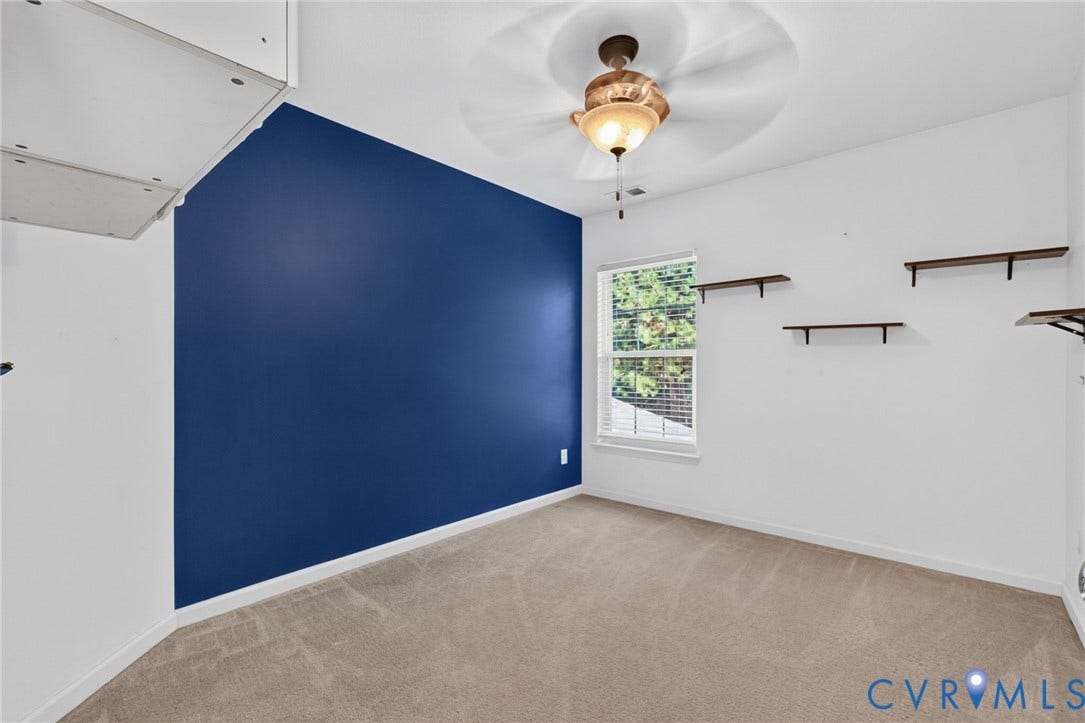 6852 Watch Harbour Circle, Hayes, VA 23072 Carpeted room featuring a ceiling fan with integrated lighting, a window with blinds, and multiple wall-mounted shelves