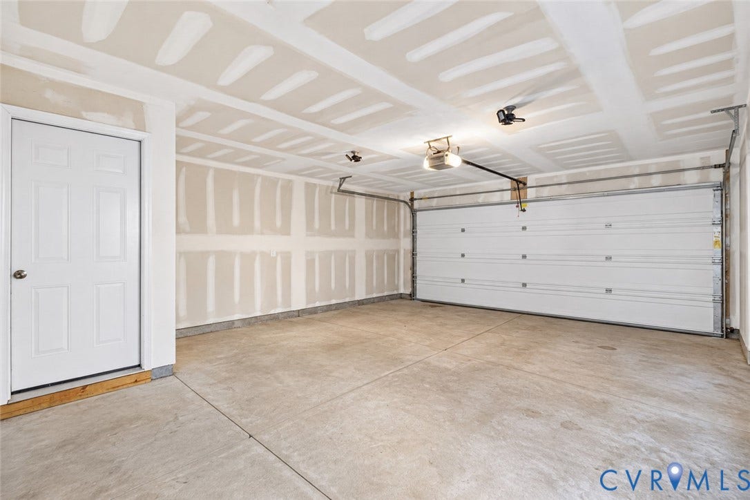 6852 Watch Harbour Circle, Hayes, VA 23072 Concrete flooring with a white paneled door and overhead lighting