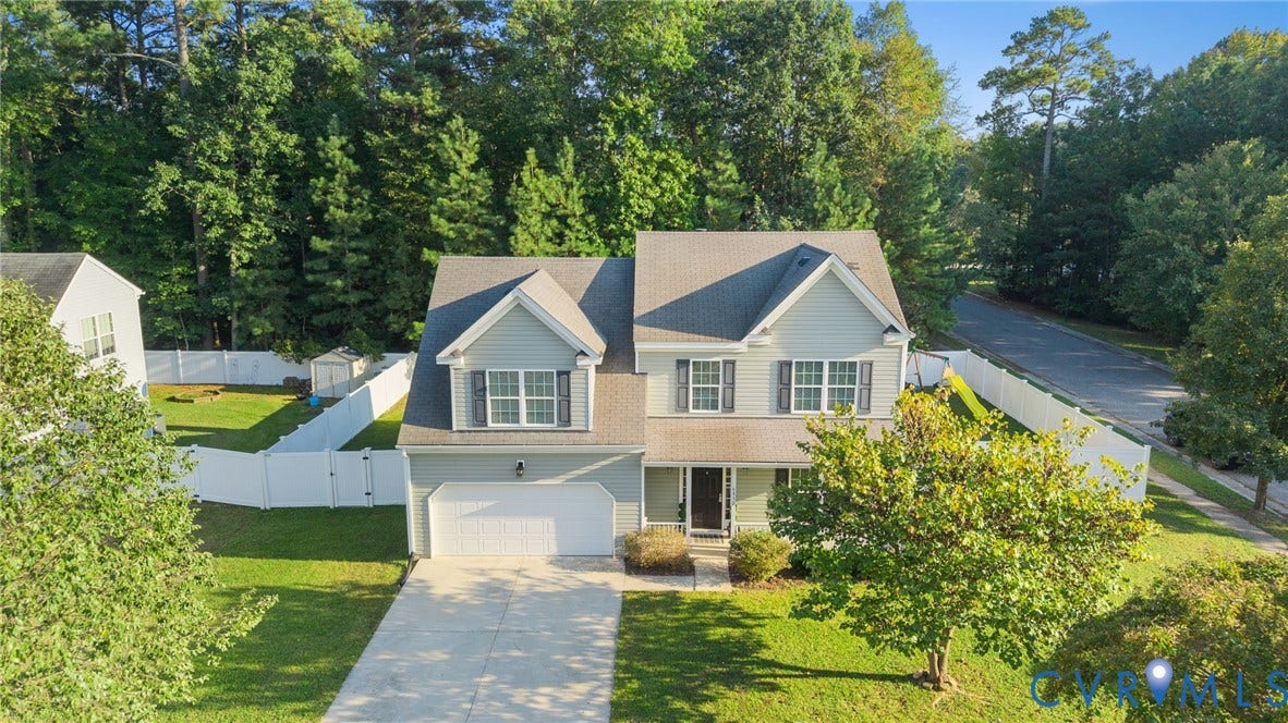 6852 Watch Harbour Circle, Hayes, VA 23072 Gabled roofline, two-car garage, mature landscaping, fenced yard, and paved driveway
