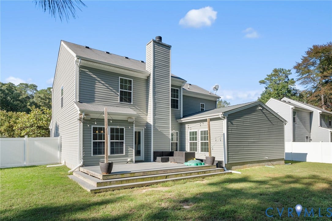 6852 Watch Harbour Circle, Hayes, VA 23072 Rear exterior with gray siding, multi-level wood deck, a white privacy fence, and an integrated extension
