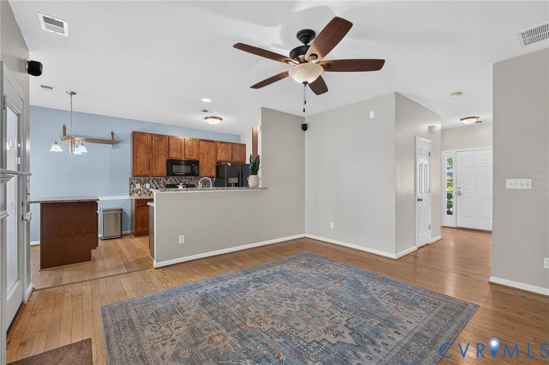 6852 Watch Harbour Circle, Hayes, VA 23072 Wood-finish flooring throughout, ceiling fan with light fixture, recessed lighting, and kitchen area with wood cabinetry