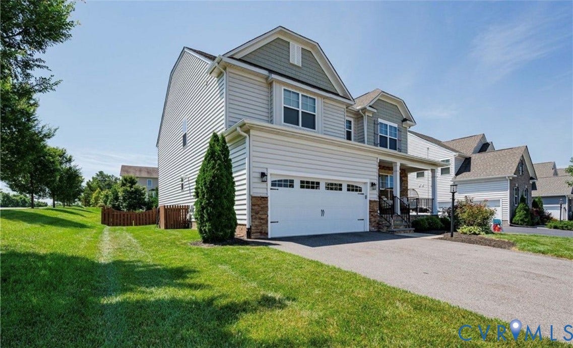 16001 Lost Crop Drive, Moseley, VA 23120 Two-story residence with a two-car garage, stone accents, and a covered front porch