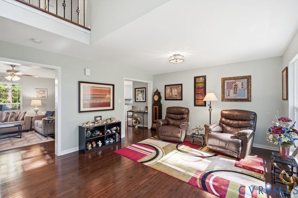 2490 Mountain Road, Glen Allen, VA 23060 Double-height ceiling, hardwood flooring, and wrought-iron staircase railing
