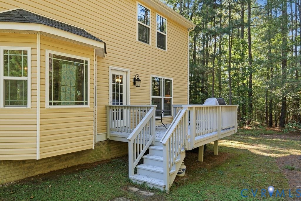 2490 Mountain Road, Glen Allen, VA 23060 Rear exterior featuring light-colored siding, a multi-pane glass door, bay window configuration, and a raised wooden deck with white railing