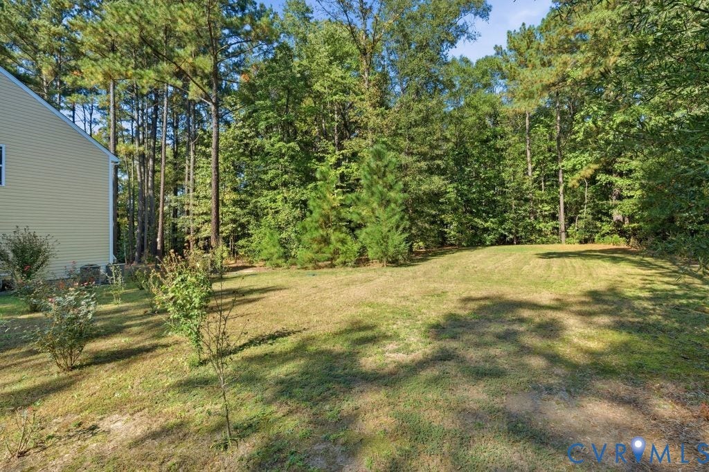 2490 Mountain Road, Glen Allen, VA 23060 Expansive backyard featuring a manicured lawn, established landscaping, and mature trees