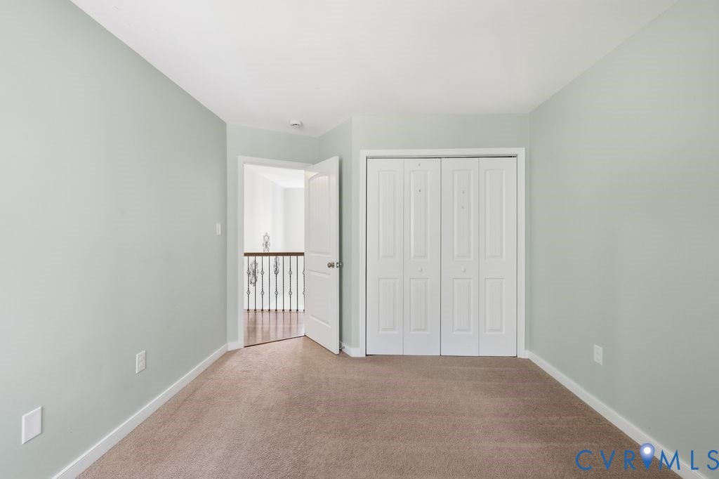 2490 Mountain Road, Glen Allen, VA 23060 Interior space featuring neutral wall paint, wall-to-wall carpeting, and a closet with white bifold doors