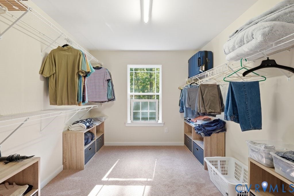 2490 Mountain Road, Glen Allen, VA 23060 Walk-in closet featuring white wire shelving, wood-finish low-profile cabinetry, and a double-hung window