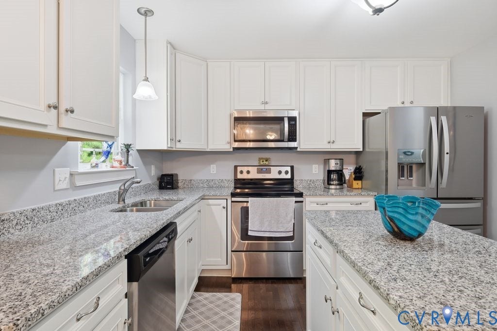 2490 Mountain Road, Glen Allen, VA 23060 Kitchen featuring white shaker-style cabinetry, stone-finish countertops, stainless steel appliances, a central island, and wood-finish flooring