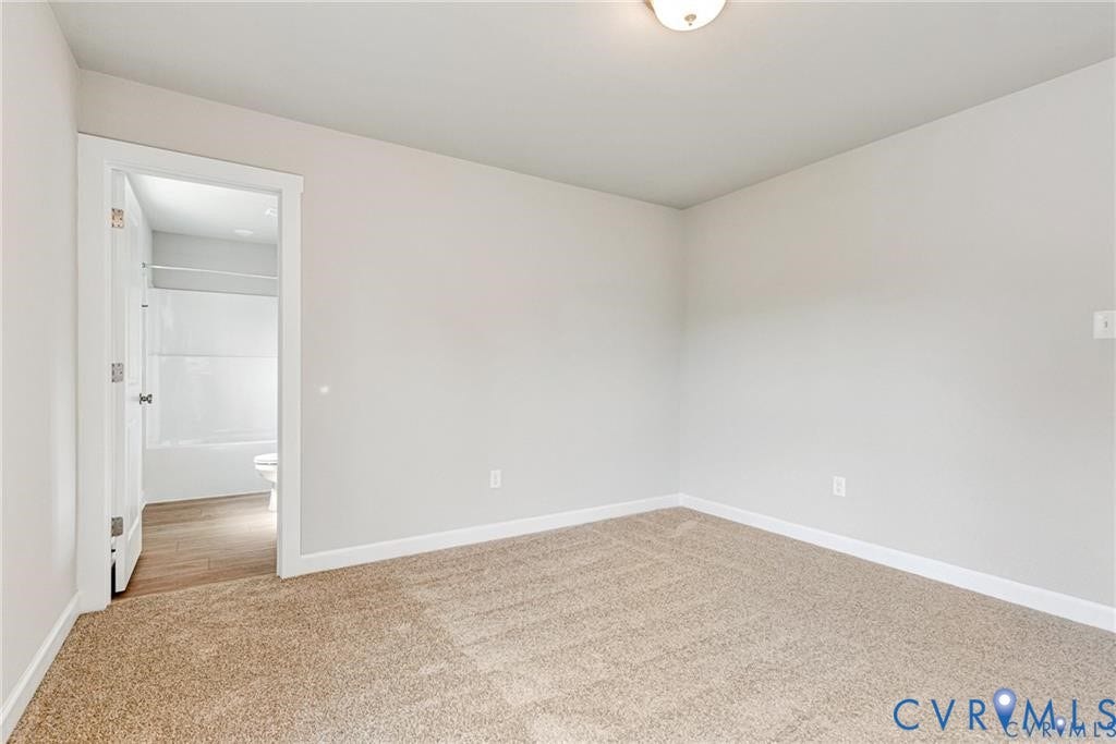 Neutral wall tones with carpeted flooring