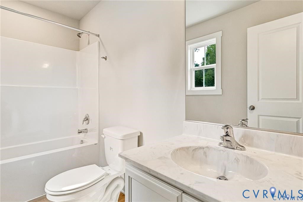 Vanity with an integrated oval sink, chrome faucet, and a light-toned countertop
