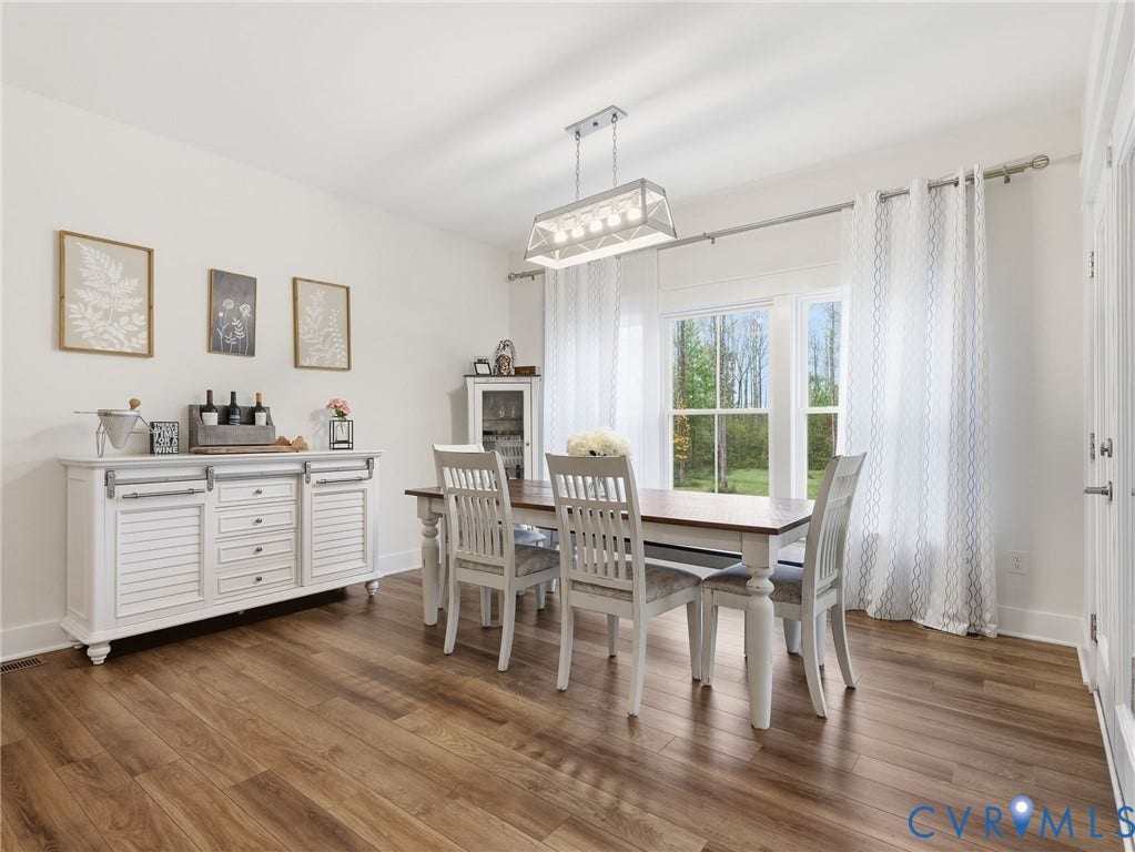 Wood-finish flooring, rectangular multi-light pendant fixture, and double-hung windows