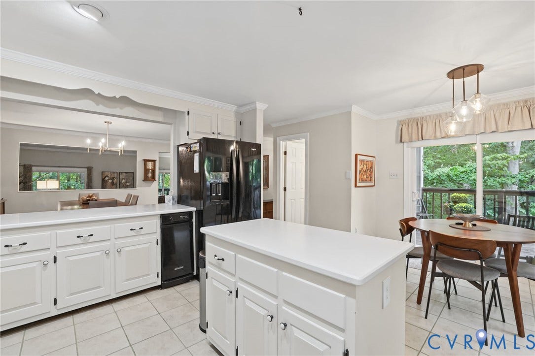 4815 Woodbriar Court, Midlothian, VA 23112 Kitchen featuring white cabinetry, a center island with a solid surface countertop, tile flooring, and sliding glass doors with exterior access