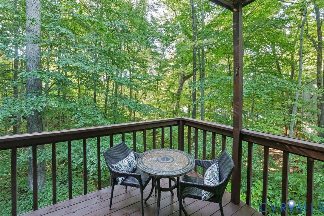 4815 Woodbriar Court, Midlothian, VA 23112 Elevated wooden deck featuring a perimeter railing and mature forest surroundings