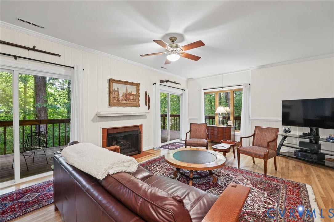 4815 Woodbriar Court, Midlothian, VA 23112 Living room featuring wood-finish flooring, a fireplace with a masonry surround, a ceiling fan, and dual sliding glass doors