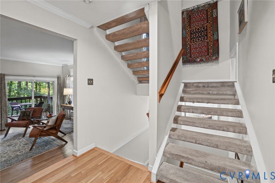 4815 Woodbriar Court, Midlothian, VA 23112 Open-riser staircase featuring wood-finish treads, a wooden handrail, and carpeted stair covers