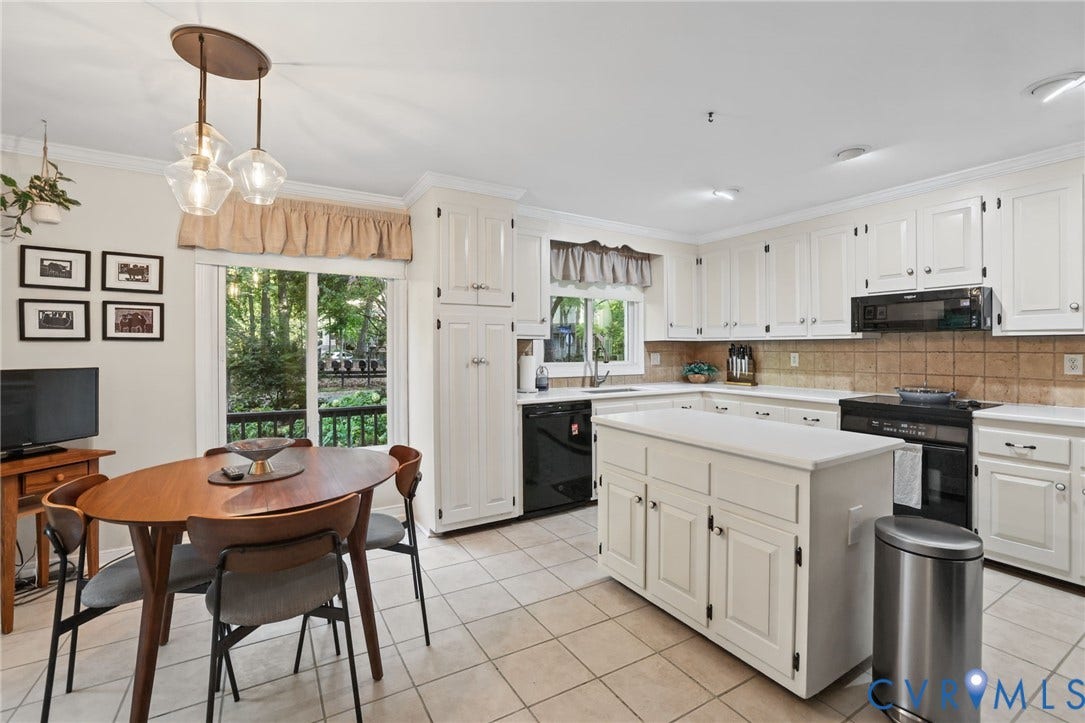 4815 Woodbriar Court, Midlothian, VA 23112 Kitchen featuring white cabinetry, center island with white countertop, ceramic tile backsplash, tile flooring, and sliding glass door