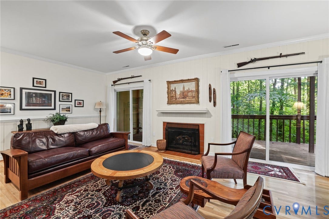 4815 Woodbriar Court, Midlothian, VA 23112 Spacious living room featuring a wood-burning fireplace, hardwood flooring, and a coffered ceiling with integrated ceiling fan