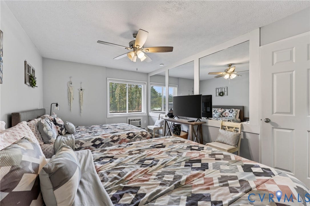 1836 FAIRWAY Drive, #218, Aspen East, Basye, VA 22810 Window with blinds, wall-mounted air conditioning unit, ceiling fan, mirrored wall paneling, and a panel door
