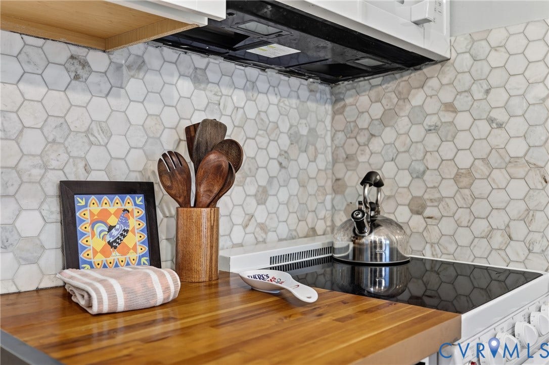 1836 FAIRWAY Drive, #218, Aspen East, Basye, VA 22810 Hexagon tile backsplash, wood-finish countertop, built-in range hood, and integrated electric stovetop
