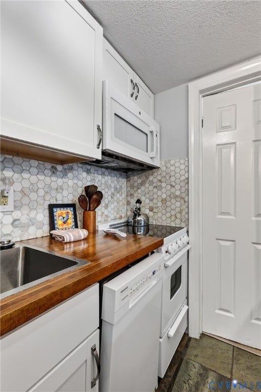 1836 FAIRWAY Drive, #218, Aspen East, Basye, VA 22810 Kitchen featuring white shaker cabinetry, wood-finish countertops, stainless steel sink, and white hexagonal tile backsplash