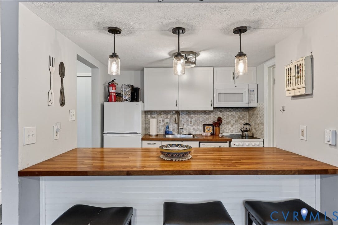 1836 FAIRWAY Drive, #218, Aspen East, Basye, VA 22810 Kitchen featuring a wood-finish countertop, white cabinetry, hexagon tile backsplash, and three pendant light fixtures