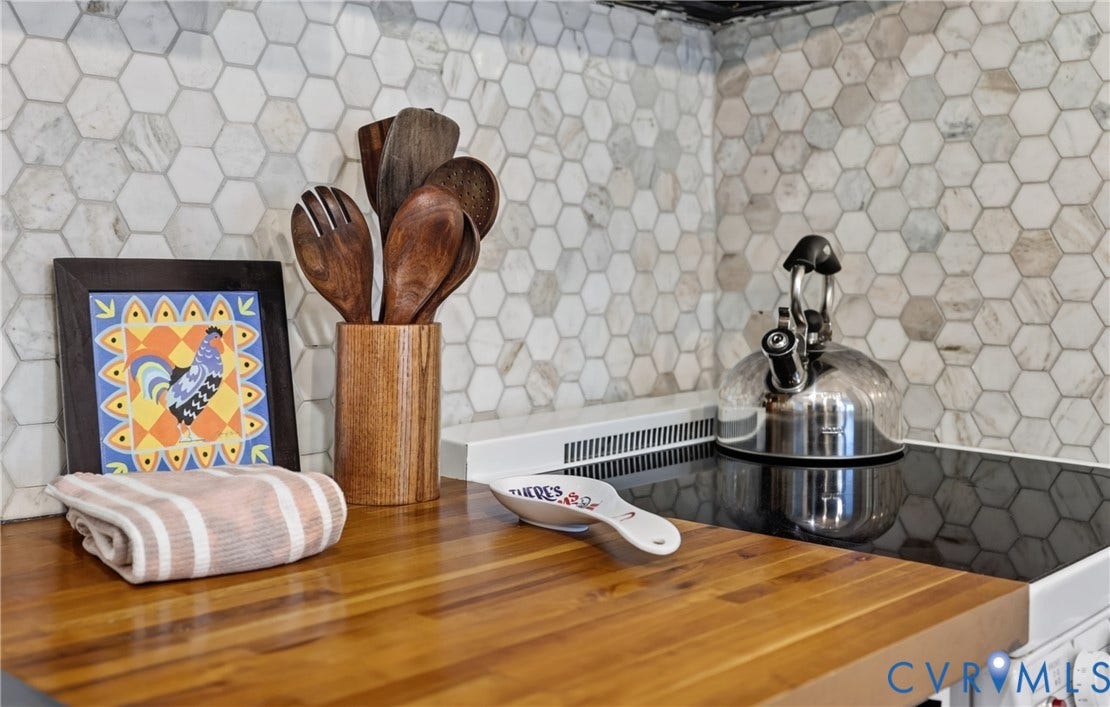 1836 FAIRWAY Drive, #218, Aspen East, Basye, VA 22810 Butcher block countertop, hexagonal tile backsplash, and a black glass cooktop