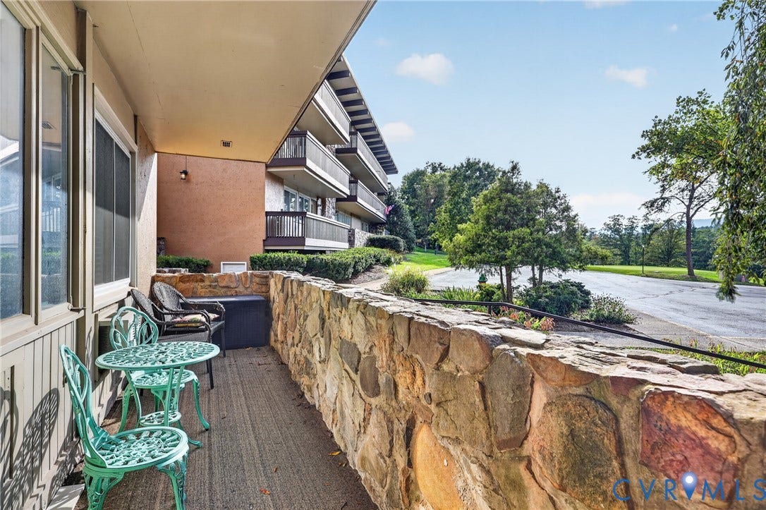 1836 FAIRWAY Drive, #218, Aspen East, Basye, VA 22810 Private balcony with a stone-clad half-wall, overlooking a tree-lined street