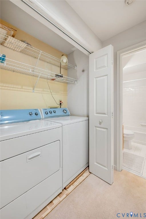 Laundry area featuring white bifod doors, wall-mounted wire shelving, and neutral carpeting