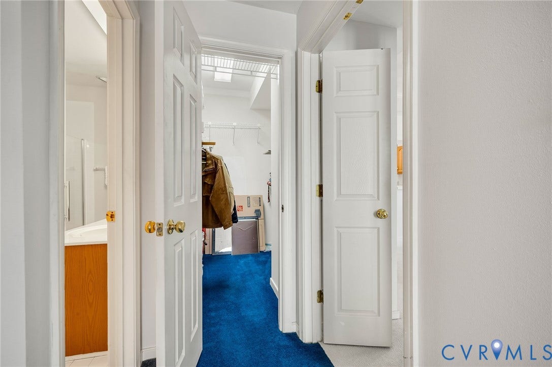 Six-panel interior doors with brass-tone hardware, built-in wire shelving, and neutral wall finishes
