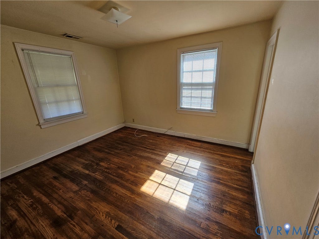 3814 Thimble Lane, Henrico, VA 23222 Wood-finish flooring, two windows with blinds, light-colored walls, and a ceiling-mounted light fixture