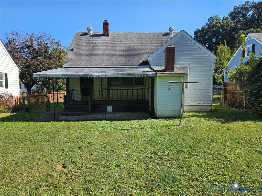 3814 Thimble Lane, Henrico, VA 23222 Rear exterior with a pitched roof, brick chimney, covered porch, and a fenced perimeter