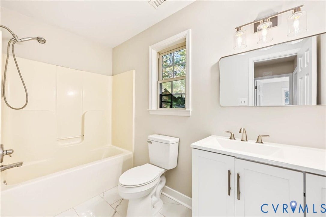 3216 Sherwood Bluff Terrace, Sherwood Bluff, Powhatan, VA 23139 Bathroom featuring a vanity with an integrated sink, polished metal faucet, multi-bulb vanity light, and a tub-shower combination with a handheld sprayer, all finished with light-toned floor tiling