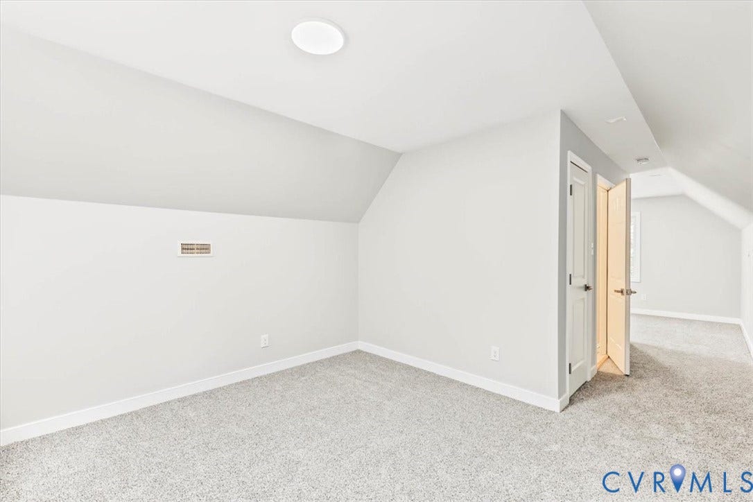 3216 Sherwood Bluff Terrace, Sherwood Bluff, Powhatan, VA 23139 Neutral-toned interior space featuring vaulted ceilings, plush wall-to-wall carpeting, and panel doors with metallic hardware