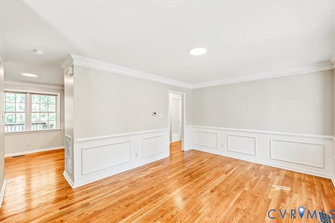 3216 Sherwood Bluff Terrace, Sherwood Bluff, Powhatan, VA 23139 Room featuring wood-finish flooring, white wainscoting, crown molding, and multi-pane windows