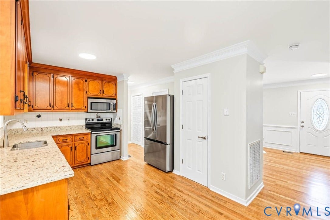 3216 Sherwood Bluff Terrace, Sherwood Bluff, Powhatan, VA 23139 Kitchen featuring natural wood cabinetry, stone-finish countertops, stainless steel appliances, and wood-finish flooring with crown molding