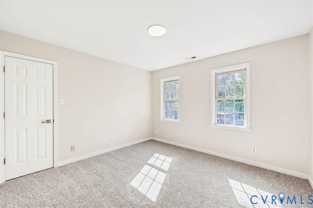 3216 Sherwood Bluff Terrace, Sherwood Bluff, Powhatan, VA 23139 Neutral interior featuring wall-to-wall carpeting, two double-hung windows, and a six-panel interior door