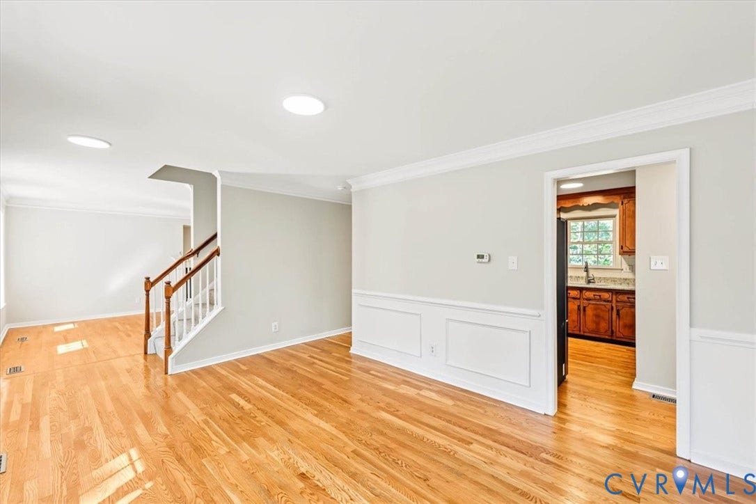 3216 Sherwood Bluff Terrace, Sherwood Bluff, Powhatan, VA 23139 Wood-finish flooring, white wainscoting, crown molding, recessed lighting, and a staircase featuring a wooden handrail with white balusters