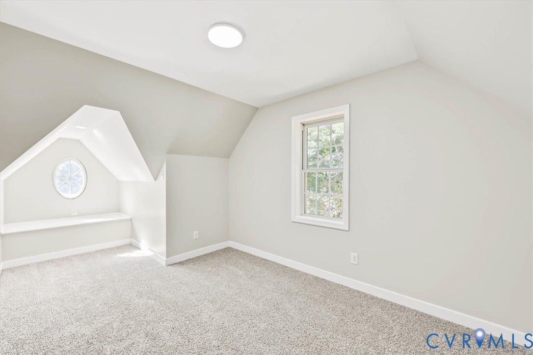 3216 Sherwood Bluff Terrace, Sherwood Bluff, Powhatan, VA 23139 Vaulted ceiling room featuring neutral-toned carpeting, a built-in window seat, an oval accent window, and a double-hung window