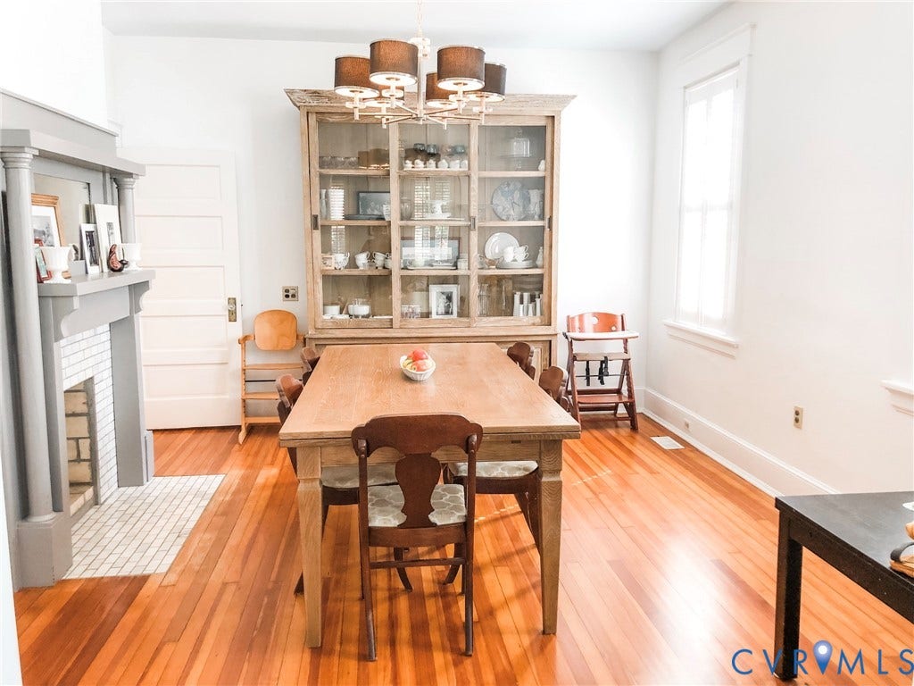 4216 Stonewall Avenue, Richmond, VA 23225 Hardwood flooring throughout, a mantel with decorative millwork, a tile-front fireplace, a built-in display cabinet, and an overhead chandelier with drum shades