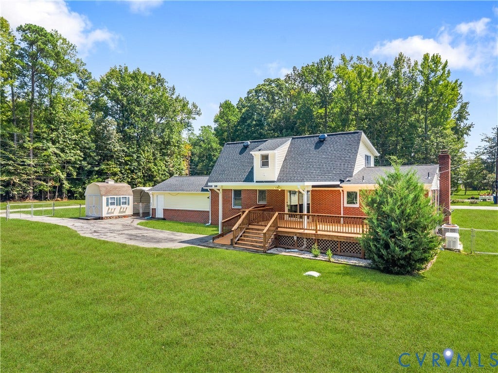 11612 Yorkdale Drive, Rivers Edge, North Prince George, VA 23860 Brick and siding exterior with a dark shingle roof, featuring a dormer window, an extensive wood-deck, and a detached shed