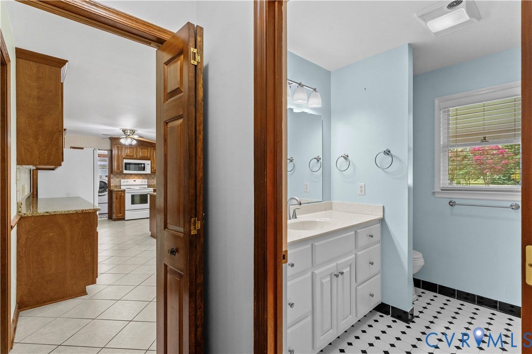 11612 Yorkdale Drive, Rivers Edge, North Prince George, VA 23860 Bathroom with a window, single vanity, and black and white floor tiling
