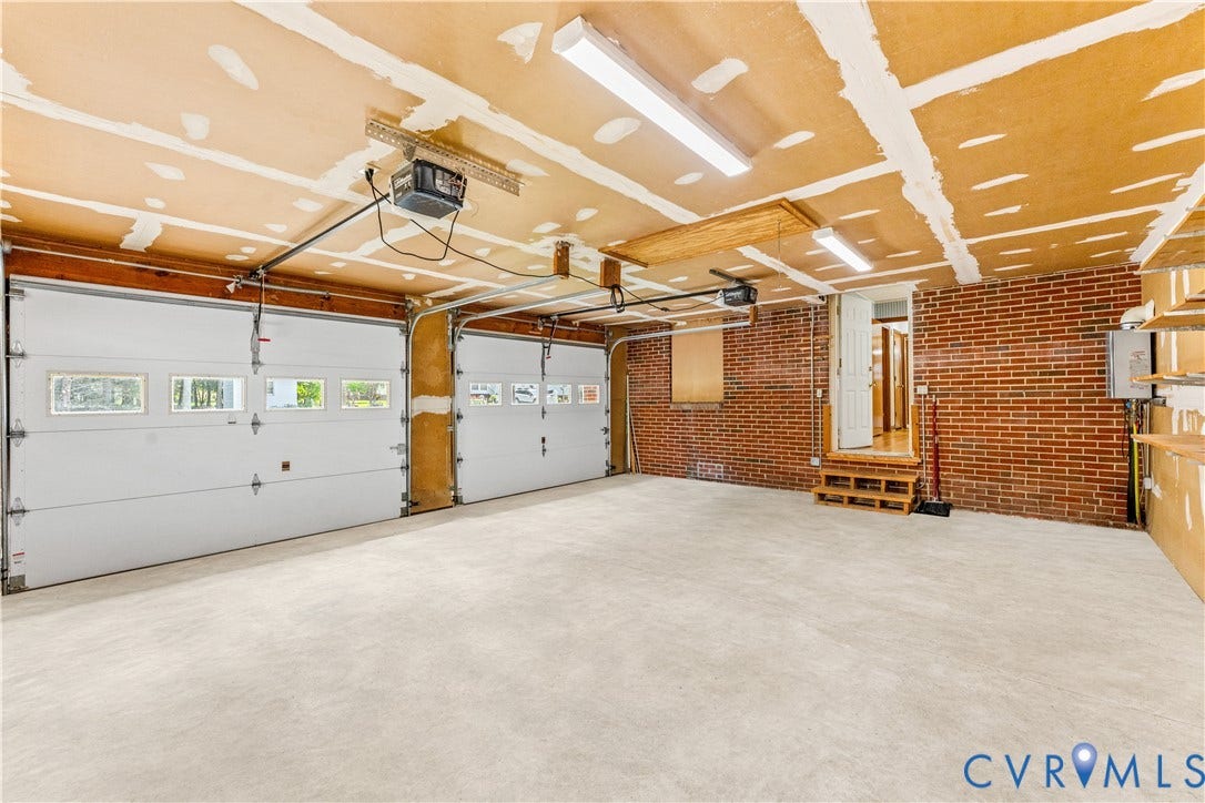 11612 Yorkdale Drive, Rivers Edge, North Prince George, VA 23860 Two-car garage featuring automatic openers, transom windows, and an exposed brick wall
