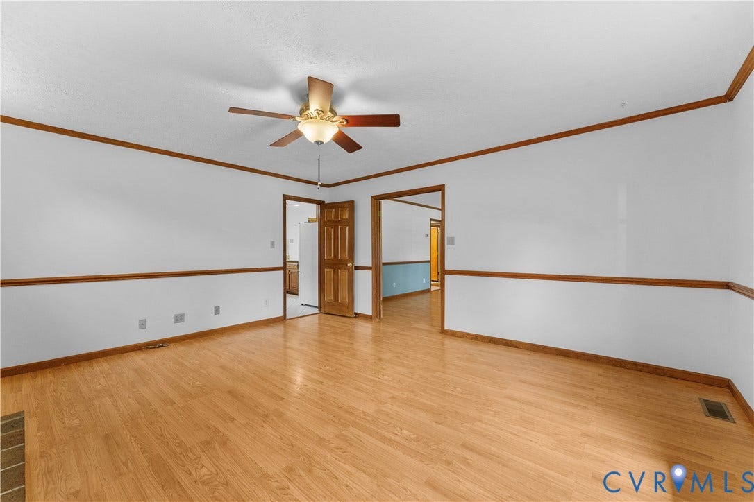 11612 Yorkdale Drive, Rivers Edge, North Prince George, VA 23860 Wood-finish flooring, white walls with wood trim, ceiling fan light fixture, and wood paneled interior doors