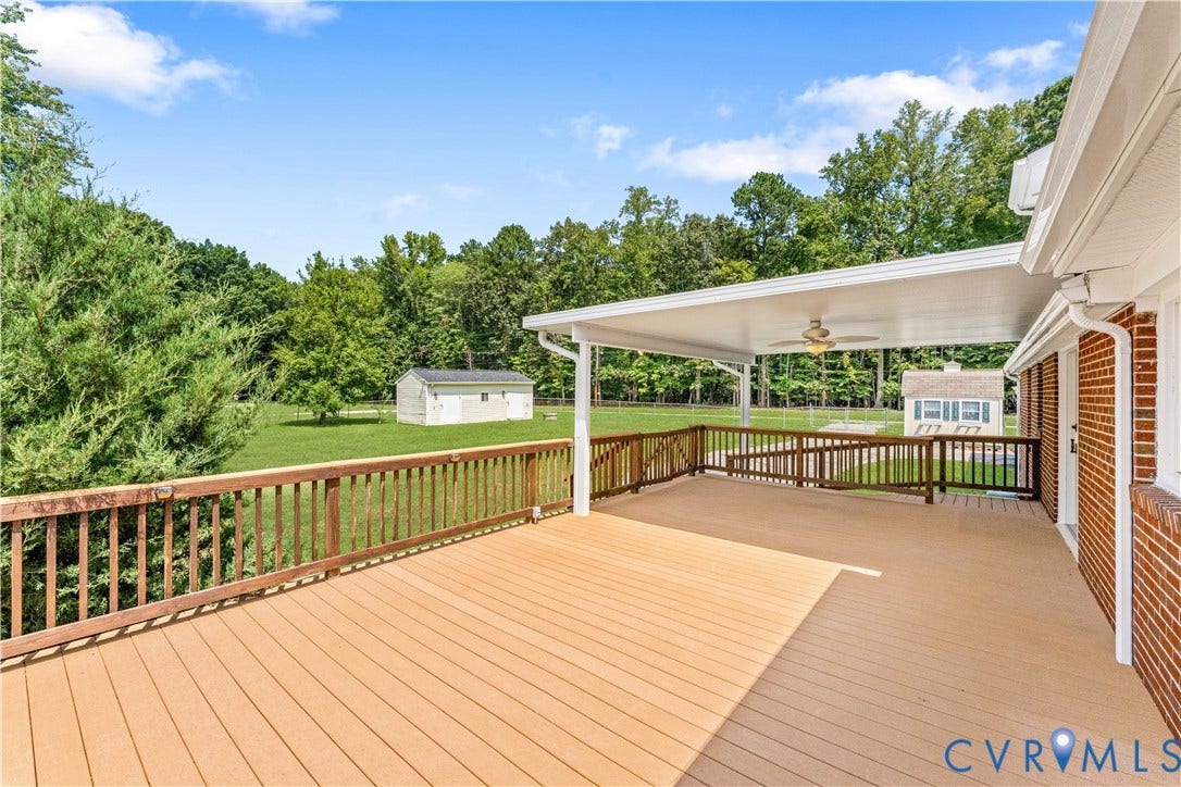 11612 Yorkdale Drive, Rivers Edge, North Prince George, VA 23860 Expansive deck with wood-finish decking, dark wood railing, and a covered portion with a ceiling fan