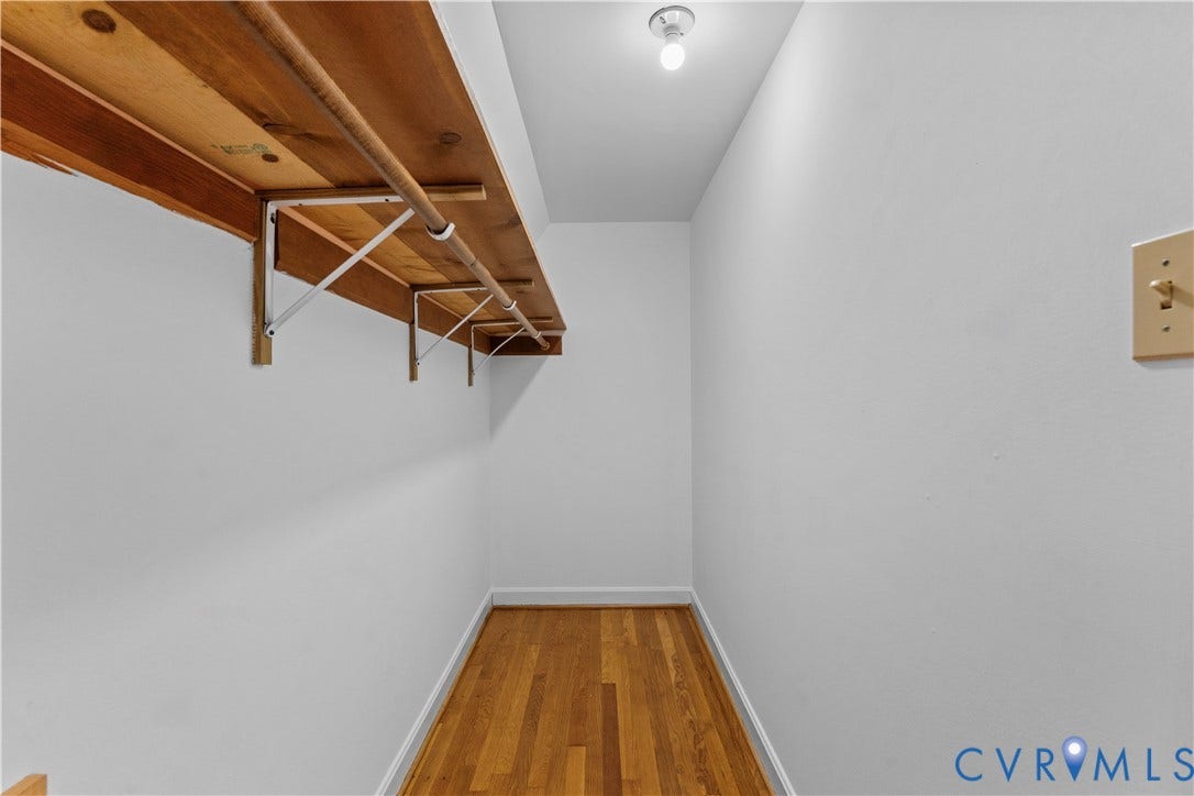 11612 Yorkdale Drive, Rivers Edge, North Prince George, VA 23860 Hardwood flooring, painted white walls, ceiling-mounted light fixture, and built-in wood shelving with hanging rod