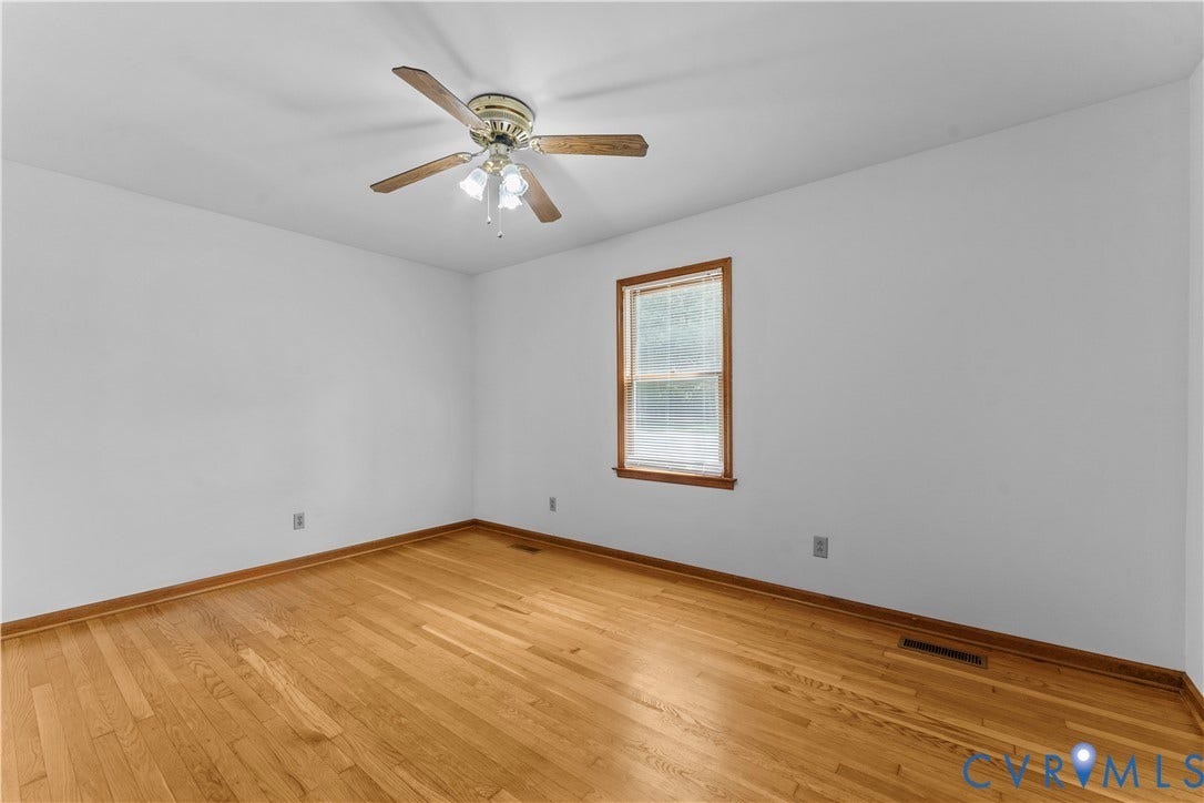 11612 Yorkdale Drive, Rivers Edge, North Prince George, VA 23860 Hardwood flooring, crisp white walls, window with wood-finish trim, and ceiling fan with lighting fixture